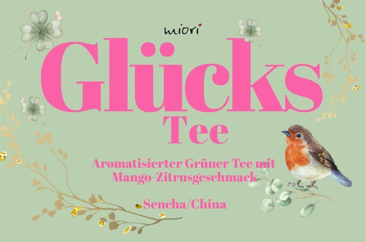 Mintgrünes Etikettmotiv Glücks Tee mit Rotkehlchen und Blütenzweigen, Untertitel Grüner Tee mit Mango-Zitrus