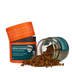 Rosenheimer Gewürzmühle Andaliman Lemonpepper: orange-petrolfarbene Dosen, eine gekippt mit ausgeschütteten getrockneten Andaliman-Beeren